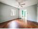 Living room with hardwood floors, a ceiling fan, and a window for natural light at 5402 Parkway Drive, Belle Isle, FL 32809