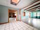 View of the living room, highlighting the wood beam ceiling and tile floors at 5402 Parkway Drive, Belle Isle, FL 32809