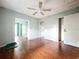 Living room with hardwood floors, a ceiling fan, and connecting rooms at 5402 Parkway Drive, Belle Isle, FL 32809