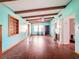 Bright living room with wood floors, beamed ceilings, and a decorative fireplace at 5402 Parkway Drive, Belle Isle, FL 32809