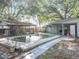 Backyard pool featuring a covered patio, perfect for outdoor relaxation and entertaining in the sun at 5402 Parkway Drive, Belle Isle, FL 32809