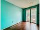Room featuring hardwood floors, blue paint, and sliding glass doors at 5402 Parkway Drive, Belle Isle, FL 32809