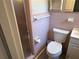 A pink tiled bathroom with a shower and traditional fixtures at 5512 Meander Ln, Lake Wales, FL 33898