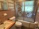 A bathroom with vintage features, including swan shower doors and pink tile at 5512 Meander Ln, Lake Wales, FL 33898