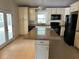 Spacious kitchen featuring an island, black appliances, and custom cabinets at 5512 Meander Ln, Lake Wales, FL 33898