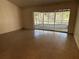 Empty living room featuring sliding glass doors to lanai at 5512 Meander Ln, Lake Wales, FL 33898