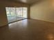 Empty living room featuring sliding glass doors to lanai at 5512 Meander Ln, Lake Wales, FL 33898