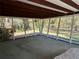 A spacious screened-in porch with wood beamed ceilings and green carpet at 5512 Meander Ln, Lake Wales, FL 33898