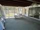 An enclosed porch with a view of the lush backyard at 5512 Meander Ln, Lake Wales, FL 33898