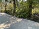 Landscaped front yard with tropical plants and a walking path at 5512 Meander Ln, Lake Wales, FL 33898
