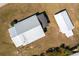 Birds eye view of a single-story home with a silver metal roof and detached storage unit at 555 Morrel Ave, Lake Wales, FL 33859