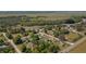 Overhead shot of home surrounded by trees and nature, complemented by nearby railway and paved roads at 555 Morrel Ave, Lake Wales, FL 33859