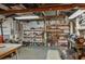Spacious basement with exposed rafters, utility shelving, work bench, and vintage tools at 555 Morrel Ave, Lake Wales, FL 33859