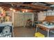 Basement view with exposed rafters, a utility sink, vintage tools, and space for storage and projects at 555 Morrel Ave, Lake Wales, FL 33859