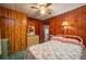 Cozy bedroom with wood paneling, floral bedding, vintage dressers and closet at 555 Morrel Ave, Lake Wales, FL 33859