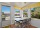 Bright dining area with large windows, patterned curtains and table with black and white chairs at 555 Morrel Ave, Lake Wales, FL 33859