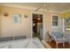Charming dining area with a ceiling fan, an adjacent kitchen, and a cozy wicker chair with throw pillows at 555 Morrel Ave, Lake Wales, FL 33859