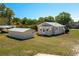 Exterior home view of a single-story residence with a separate storage outbuilding at 555 Morrel Ave, Lake Wales, FL 33859
