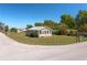 Exterior front view of a house at an intersection with a well-kept lawn and established trees at 555 Morrel Ave, Lake Wales, FL 33859