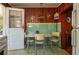 Kitchen area shows dining table with chairs, light green tile accents, and retro wood paneling at 555 Morrel Ave, Lake Wales, FL 33859