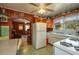 Retro kitchen with vintage appliances, adjacent to living room, and green tile floors at 555 Morrel Ave, Lake Wales, FL 33859