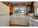 Classic kitchen with vintage appliances, white cabinets, and a window view at 555 Morrel Ave, Lake Wales, FL 33859