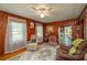 Cozy living room with wood paneled walls, ceiling fan, and vintage accents at 555 Morrel Ave, Lake Wales, FL 33859