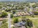 Wide aerial shot highlighting property's location in a tranquil neighborhood near a golf course and lake at 602 Turnberry Ct, Winter Haven, FL 33884