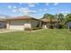 Charming single-story home with attached garage and well-maintained lawn and tropical landscaping at 602 Turnberry Ct, Winter Haven, FL 33884