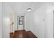 Bright entryway featuring wood-look floors and white walls, leading into the kitchen at 6433 Jacaranda Ne Ave, Winter Haven, FL 33881