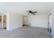 Spacious living room with neutral carpet, ceiling fan, and easy access to other rooms at 6433 Jacaranda Ne Ave, Winter Haven, FL 33881