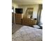 This bedroom features a tv, a dresser with a mirror, a nightstand, and a bed with a floral patterned comforter at 6515 Raintree Ne Ln, Winter Haven, FL 33881