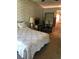 The bedroom features a work space, a bed with a floral comforter, and light wallpaper at 6515 Raintree Ne Ln, Winter Haven, FL 33881