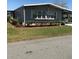 Charming single-story home featuring well-maintained landscaping and covered parking at 6515 Raintree Ne Ln, Winter Haven, FL 33881