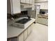 Kitchen area featuring an island cooktop, abundant counter space, and functional appliances at 6515 Raintree Ne Ln, Winter Haven, FL 33881