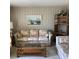 Comfortable living room featuring bamboo furniture, floral patterned sofa, and shelving at 6515 Raintree Ne Ln, Winter Haven, FL 33881