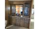 The living space features a wet bar with lots of storage, as well as a sink and mirrored backsplash at 6515 Raintree Ne Ln, Winter Haven, FL 33881