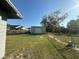 Exterior view of a metal storage shed with a backyard at 707 Great Barford St, Auburndale, FL 33823