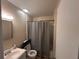 Bathroom featuring a single sink vanity, toilet, and a shower/tub with a curtain at 707 Great Barford St, Auburndale, FL 33823