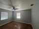 Bedroom with wood floors, neutral walls, ceiling fan, and windows with blinds at 707 Great Barford St, Auburndale, FL 33823