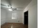 Bedroom featuring neutral walls, wood floors, a window with blinds, and closet at 707 Great Barford St, Auburndale, FL 33823