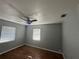 Bedroom with wood floors, neutral walls, ceiling fan, and dual windows with blinds at 707 Great Barford St, Auburndale, FL 33823