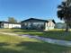 Charming single-story home featuring a well-manicured lawn and dark brick exterior at 707 Great Barford St, Auburndale, FL 33823