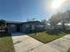 Charming single-story home featuring a well-manicured lawn, dark brick exterior, and a cozy, inviting curb appeal at 707 Great Barford St, Auburndale, FL 33823