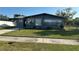 Charming single-story home featuring a well-manicured lawn, dark brick exterior, and a cozy, inviting curb appeal at 707 Great Barford St, Auburndale, FL 33823