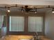 Bright kitchen featuring a stainless steel sink, granite counters, track lighting, and two large windows at 707 Great Barford St, Auburndale, FL 33823