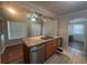 Kitchen island with stainless steel appliances, granite countertops, sink, and track lighting at 707 Great Barford St, Auburndale, FL 33823