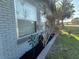 Close up of landscaping with ornamental plants and brick border at 707 Great Barford St, Auburndale, FL 33823