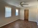 Living room with ceiling fan and wood-look tile at 707 Great Barford St, Auburndale, FL 33823