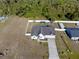 Aerial view of the property showing the home's layout, the driveway, and the fenced backyard surrounded by greenery at 747 Fraser Ct, Kissimmee, FL 34759